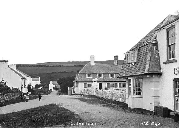 Cushendun - a view of the buildings and children in the street