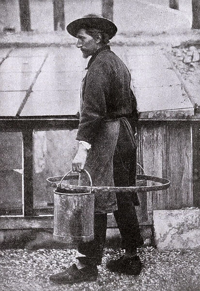 Man carrying water in buckets, France