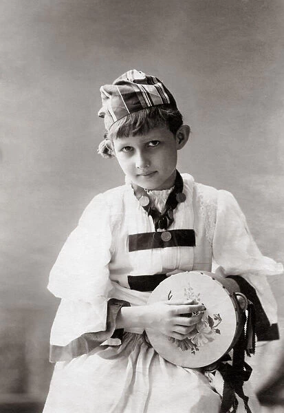 Young European boy with tambourine, India, c. 1880 s
