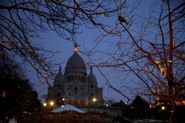 A view shows the Sacre Coeur basilica at the Butte Montmartre in the early morning in