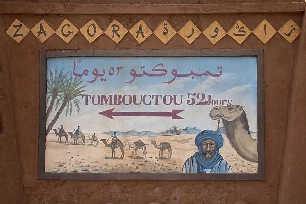 Tombouctou 52 days direction sign in desert town, Zagora, Sahara, Morocco, may