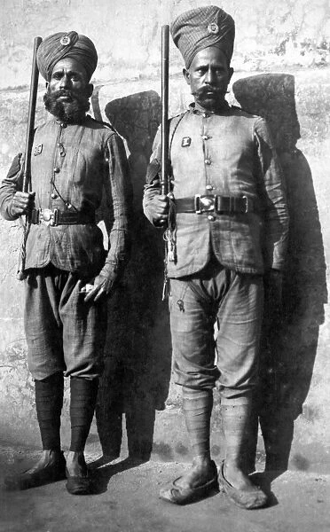 BURMA: PRISON GUARDS. Two armed and uniformed prison guards standing next to a wall