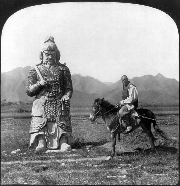 CHINA: MING TOMBS, c1907. A Chinese man on his donkey standing next to one of the