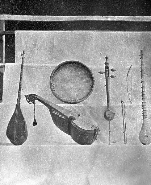 MUSICAL INSTRUMENTS. Various string instruments and bows and a frame drum from Central Asia