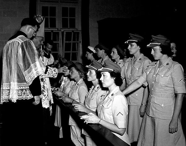 WOMEN MARINES, 1943. Reverend Eugene McGuinness administering the sacrament of