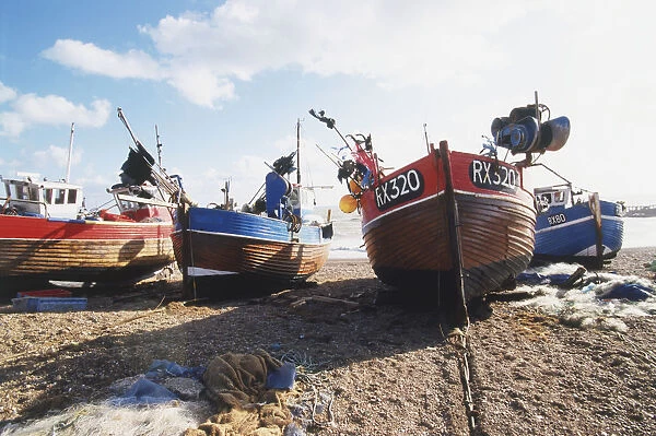 Great Britain, England, Hastings, fishing boats moored on beach, front view
