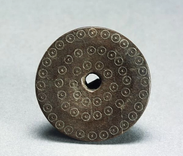 Spindle whorl decorated with evil eye