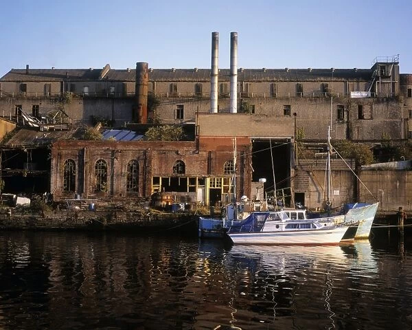 Fishing boats near a derelict factory, River Boyne, Drogheda, Co Louth, Ireland