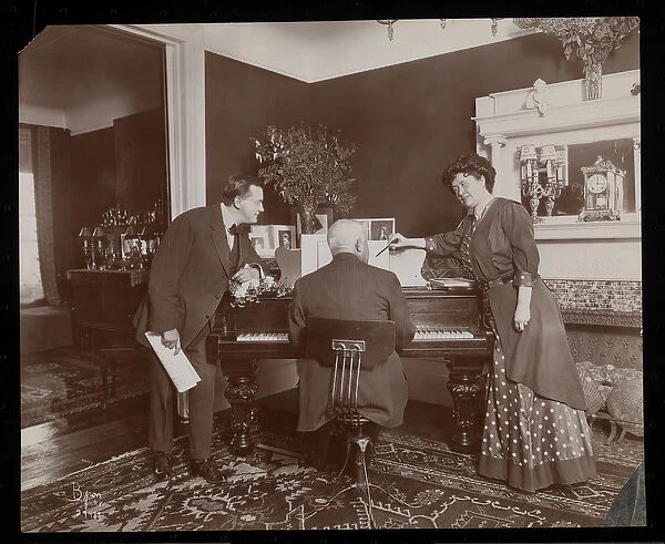 Clara De Regand pointing to a score while a man plays the piano