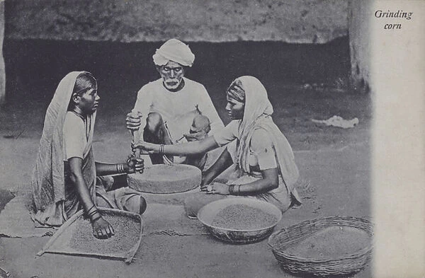 Man and women grinding corn, North Africa (b  /  w photo)
