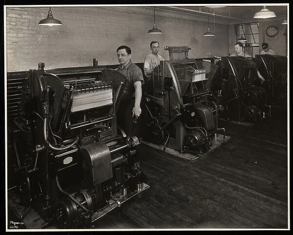 Men working printing presses at Unz & Co. 24 Beaver Street, New York