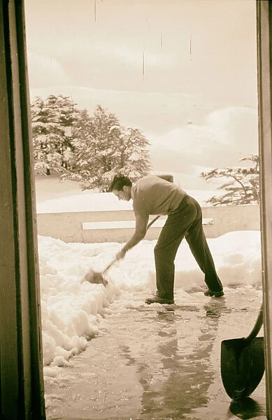 Man shoveling snow Hotel des Cedres Cedars Lebanon