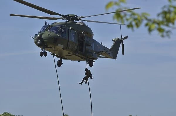 A pathfinder of the Belgian Army fast-roping from a NH90 helicopter