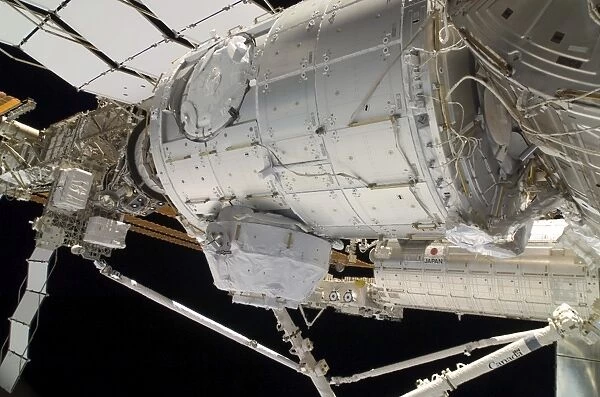 The Pressurized Mating Adapter 3 in the grasp of the Canadarm2