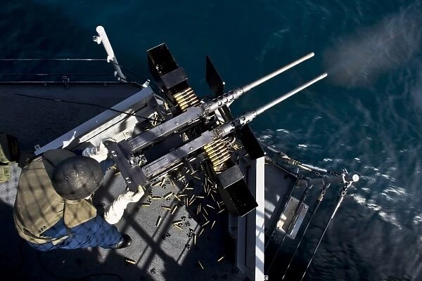 Seaman fires twin. 50 caliber machine guns aboard USS Boxer