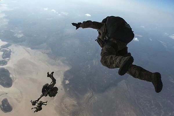 U. S. Pararescuemen and U. S. Marines jump from a HC-130 over Djibouti