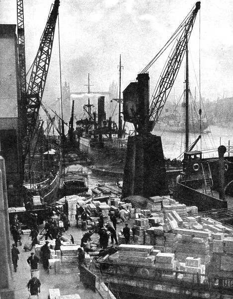 Cargo being unloaded at the docks, Upper Pool, London, 1936. Artist: Fox