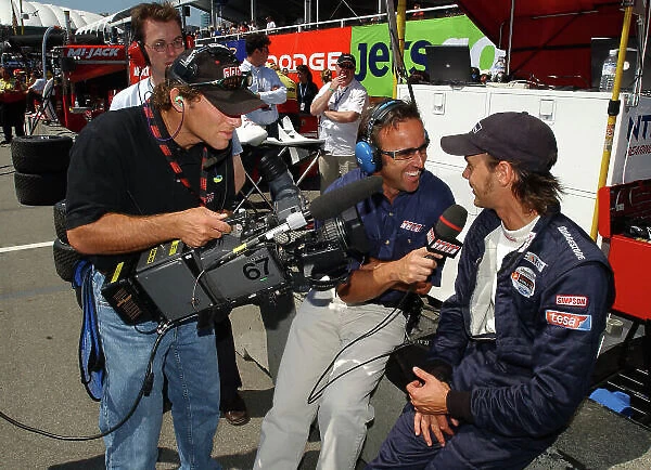 2003 Champ Car Series 25-27 July 2003 Molson Indy Vancouver Vancouver, BC. Calvin Fish of SpeedChannel interviews Darren Manning. 2003 Dan R. Boyd USA LAT Photographic