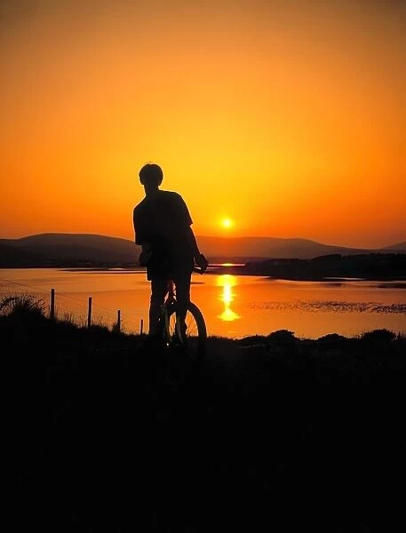 Achill Island, Co Mayo, Ireland; Silhouetted Man On A Mountain Bike