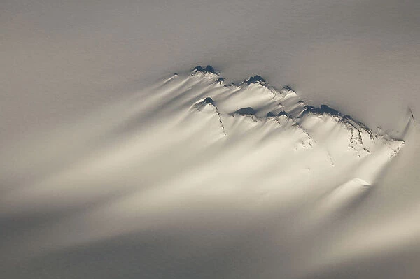Aerial Of A Windswept Nunatak On The Harding Ice Field In Kenai Fjords National Park, Southcentral Alaska, Winter