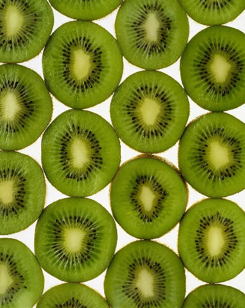 Agriculture - Kiwi slices arranged in rows and backlit, studio. Version 2