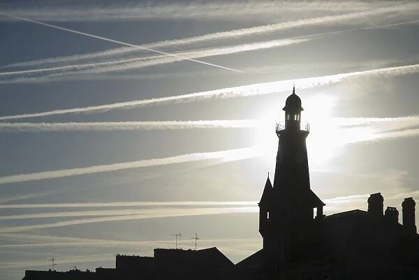 Airplane Contrails Above Lighthouse