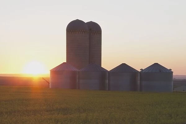 Alberta, Canada; Grain Bins At Sunrise