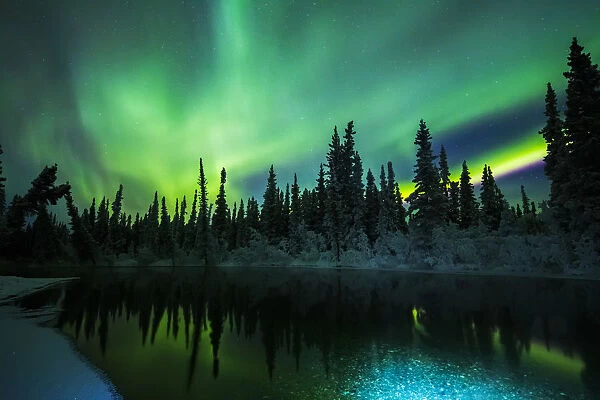 The Aurora Reflects In The Clearwater River In Delta Junction; Alaska, United States Of America