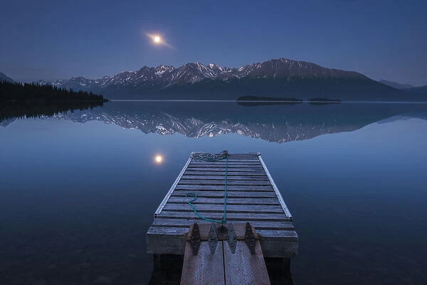 Boat Dock With A Full Moon Rising Over The Chigmit Mountains At Lake Clark In Lake Clark National Park And Preserve, Alaska