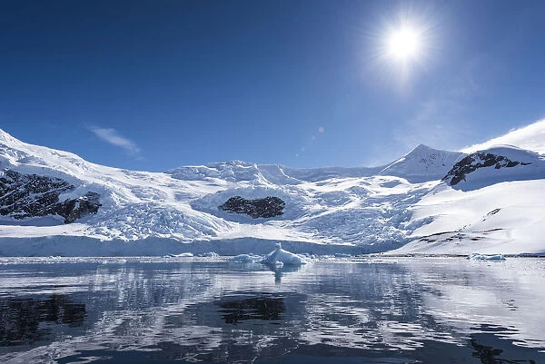 Bright Sun And Snow On The Mountains Reflected In The Water Of Neko Harbour; Antarctica