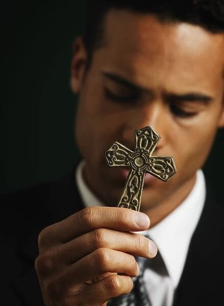 Businessman Holding Out A Cross