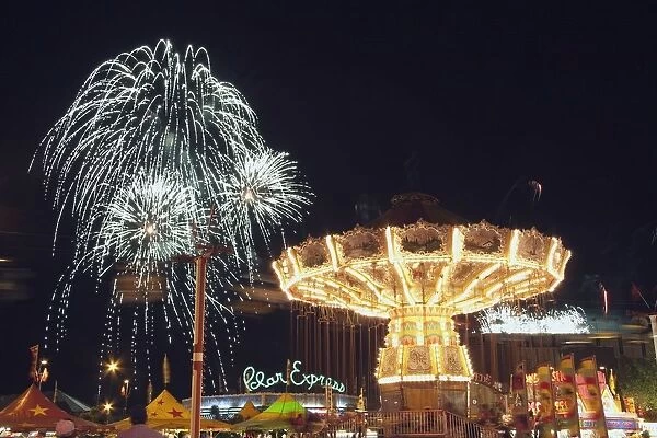 Calgary, Alberta, Canada; Midway Rides At Night With Fireworks At The Calgary Stampede