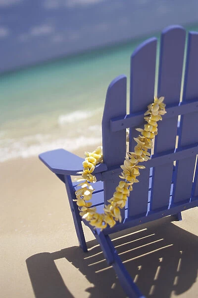 Close-Up Side Of Blue Beach Chair With Plumeria Hanging On Side