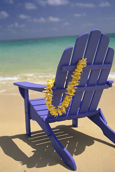 Close-Up Blue Beach Chair With Plumeria Hanging On Side Facing Ocean