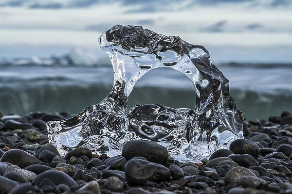 Close-up of a piece of ice on a pebble beach