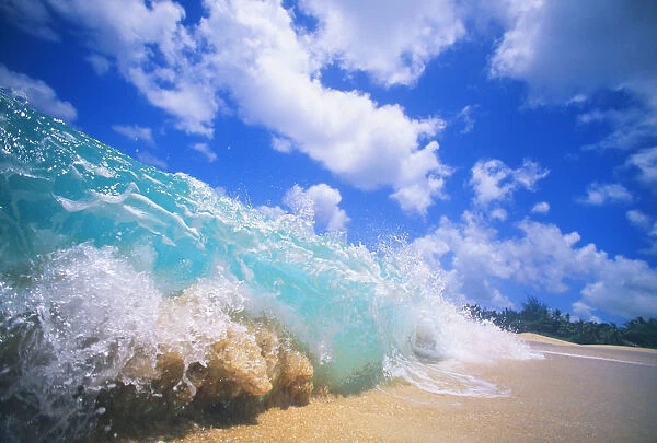 Closeup Action Of Shorebreak Ocean Wave, Turbulent Motion Blue Sky With Puffy Clouds