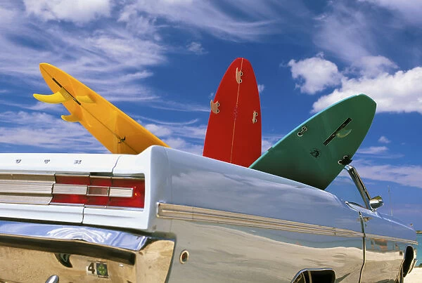 Colorful Surfboards In Vintage Plymouth Fury, Puffy Clouds In Background