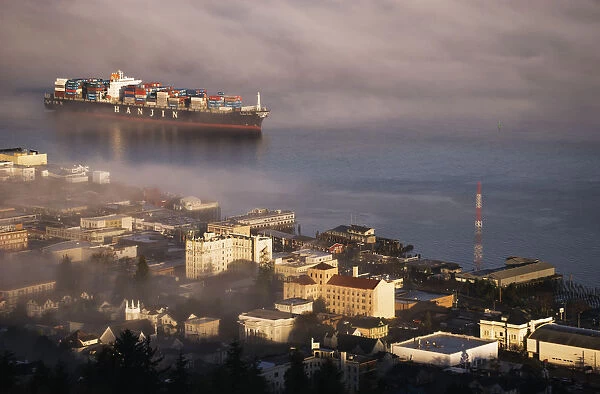 A Container Ship Emerges From The Fog; Astoria, Oregon, United States Of America