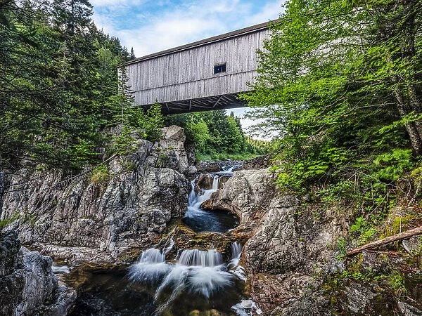 Covered bridge over a waterfall