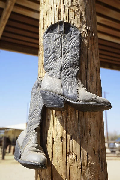 Cowboy Boots Hanging From A Post At A Riding Ranch; Arizona Usa