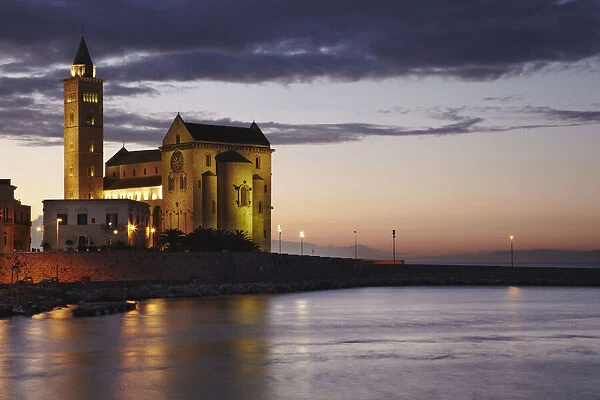 A dusk view of the harborside cathedral in Trani