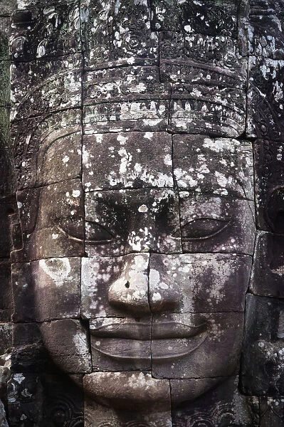 A face sculpture on a stone wall at angkor wat; Cambodia