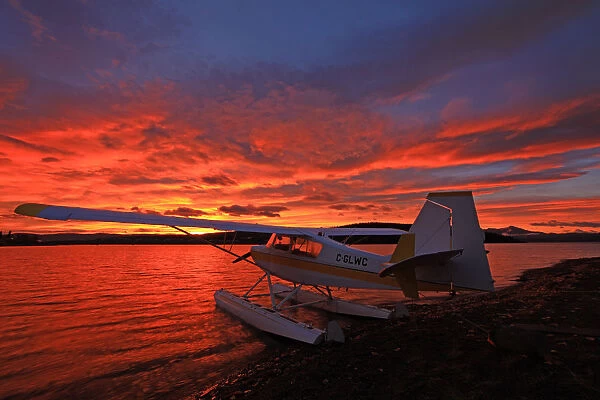 A Float Plane Facing The Sunrise Over Teslin Lake, Yukon