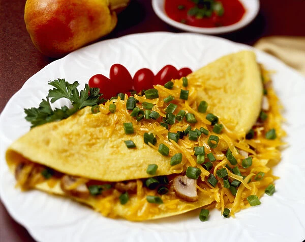 Food - Cheese and Mushroom Omelette garnished with chopped green onions (scallions) and pear tomatoes
