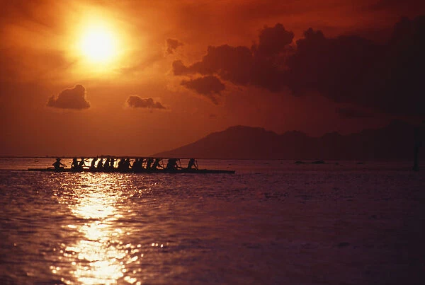 French Polynesia, Tahiti, Moorea, Bora Bora, Outrigger Canoeing At Sunset, Orange Sky