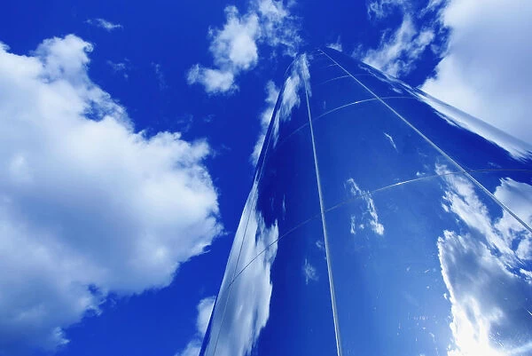 Glass Obelisk With Blue Sky And Cloud Reflections