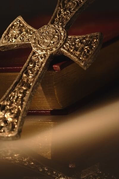Gold Cross Resting On Closed Bible
