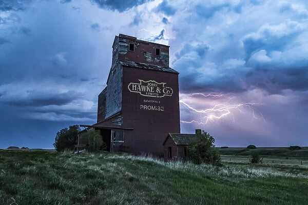 Grain elevator and storm on the prairies