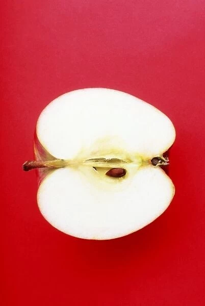 Half An Apple On Red Background