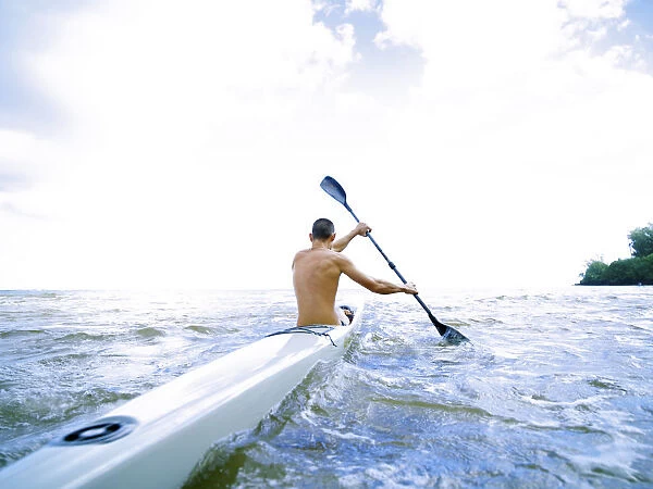 Hawaii, Kauai, Anini Beach, Active Male Paddling In A One Man Canoe